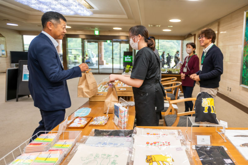 「b-らいふ」様のキッチンカーと物販のブースの様子